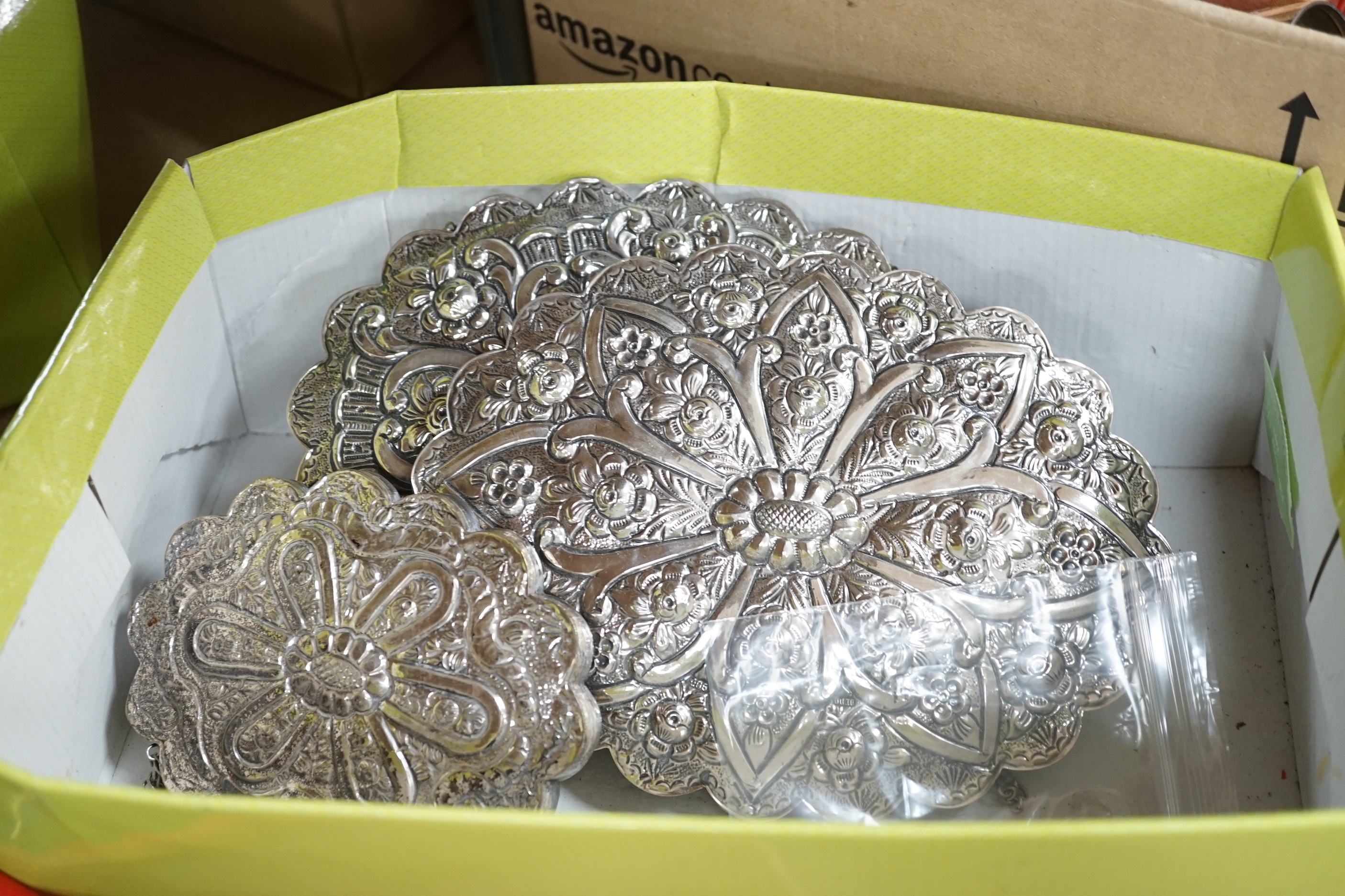 Seven assorted 20th century Persian repousse white metal mounted shaped oval or round mirrors, largest 21cm.